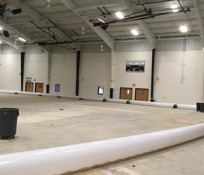 Large gym with air movers on floor.