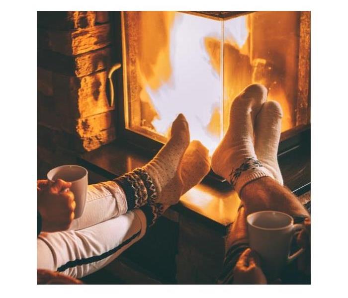 Fire going in a fireplace with socks on feet